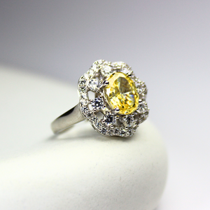 Saffra Ring in 92.5 sterling silver, featuring a stunning yellow gemstone surrounded by delicate sparkling diamonds. Tarnish-free, hypoallergenic, and perfect for sensitive skin—radiating warmth, elegance, and timeless charm.